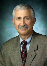 Headshot photo of Jed Fahey wearing a suit