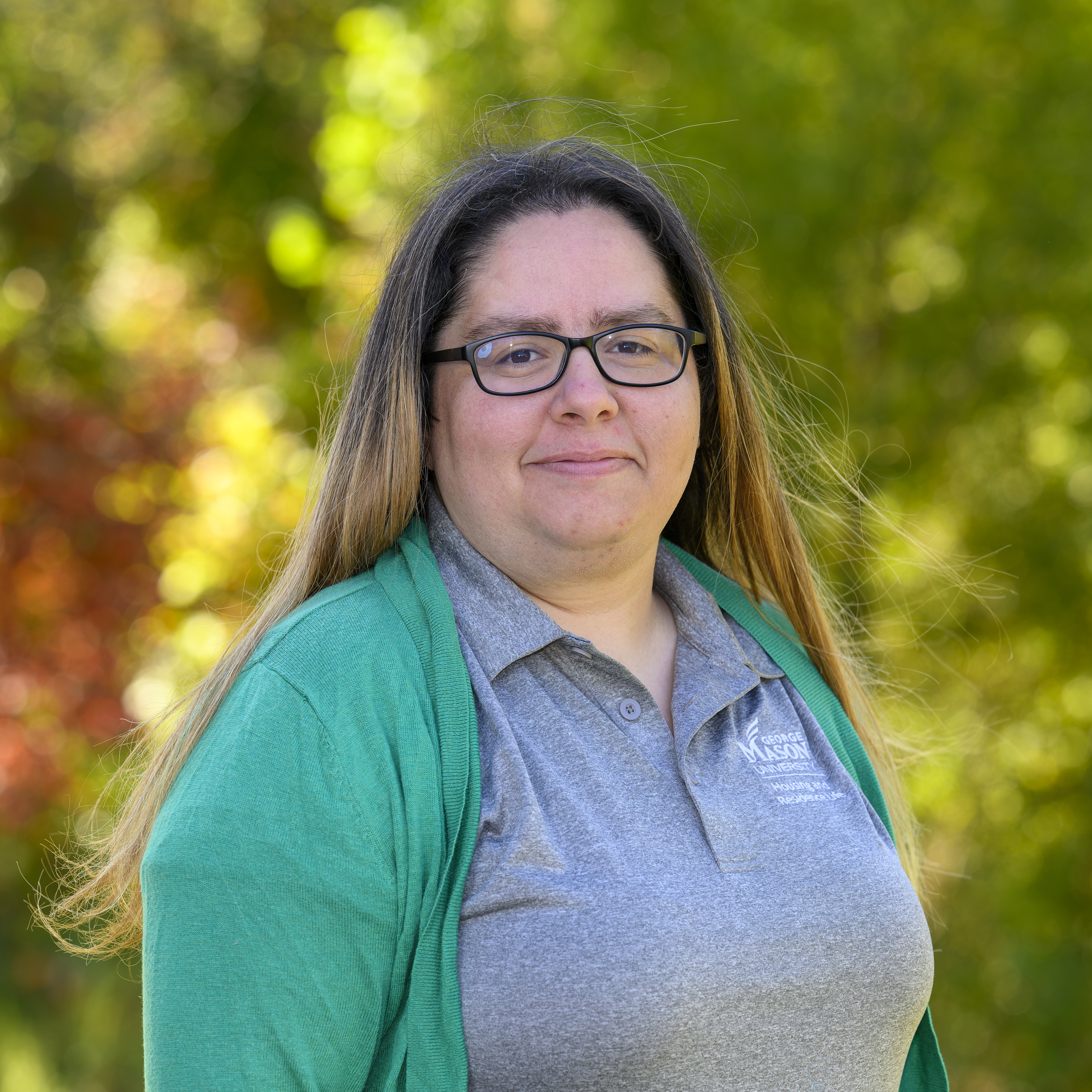 Colleen Moore in a grey polo and green cardigan. 