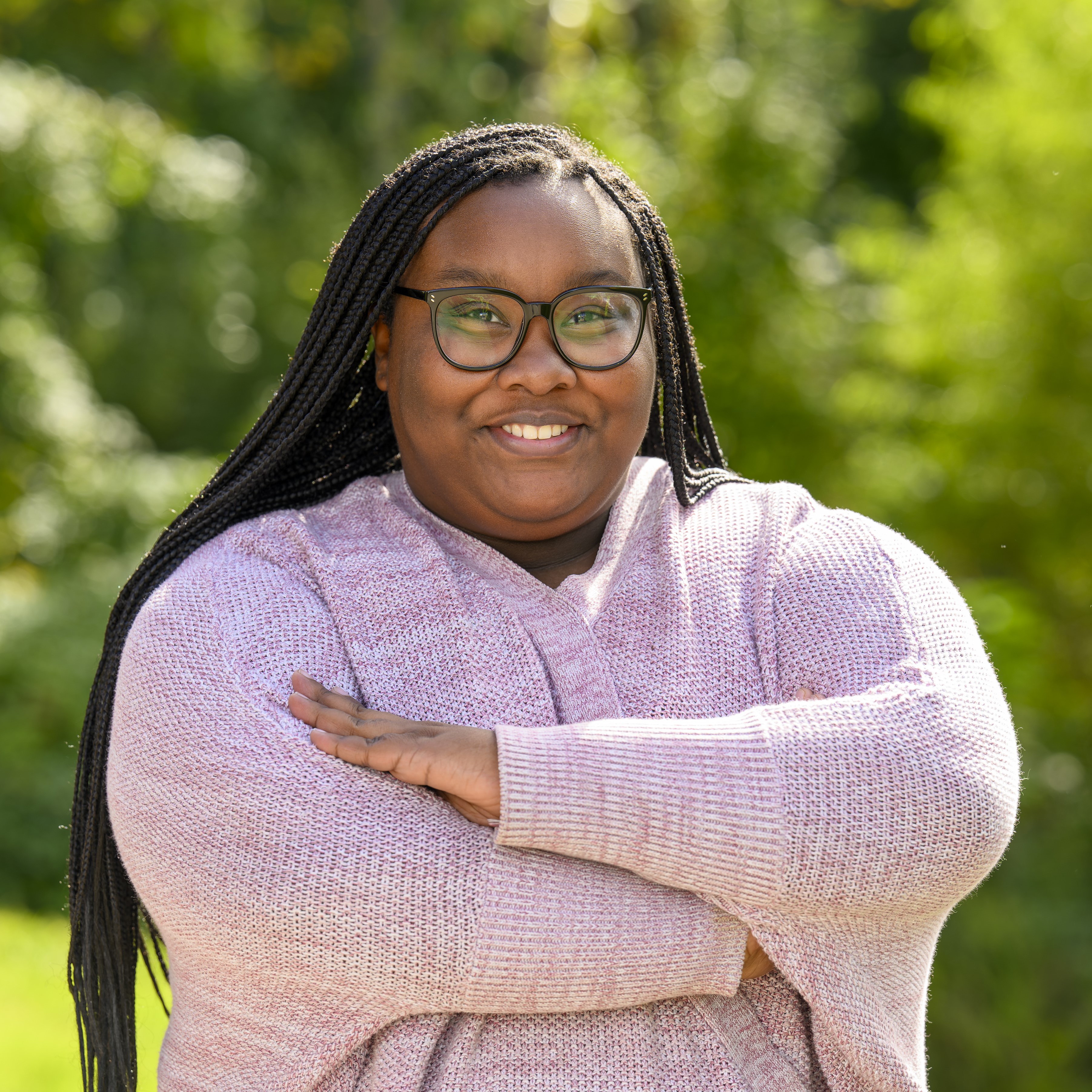 Paula Harris in a light pink sweater.