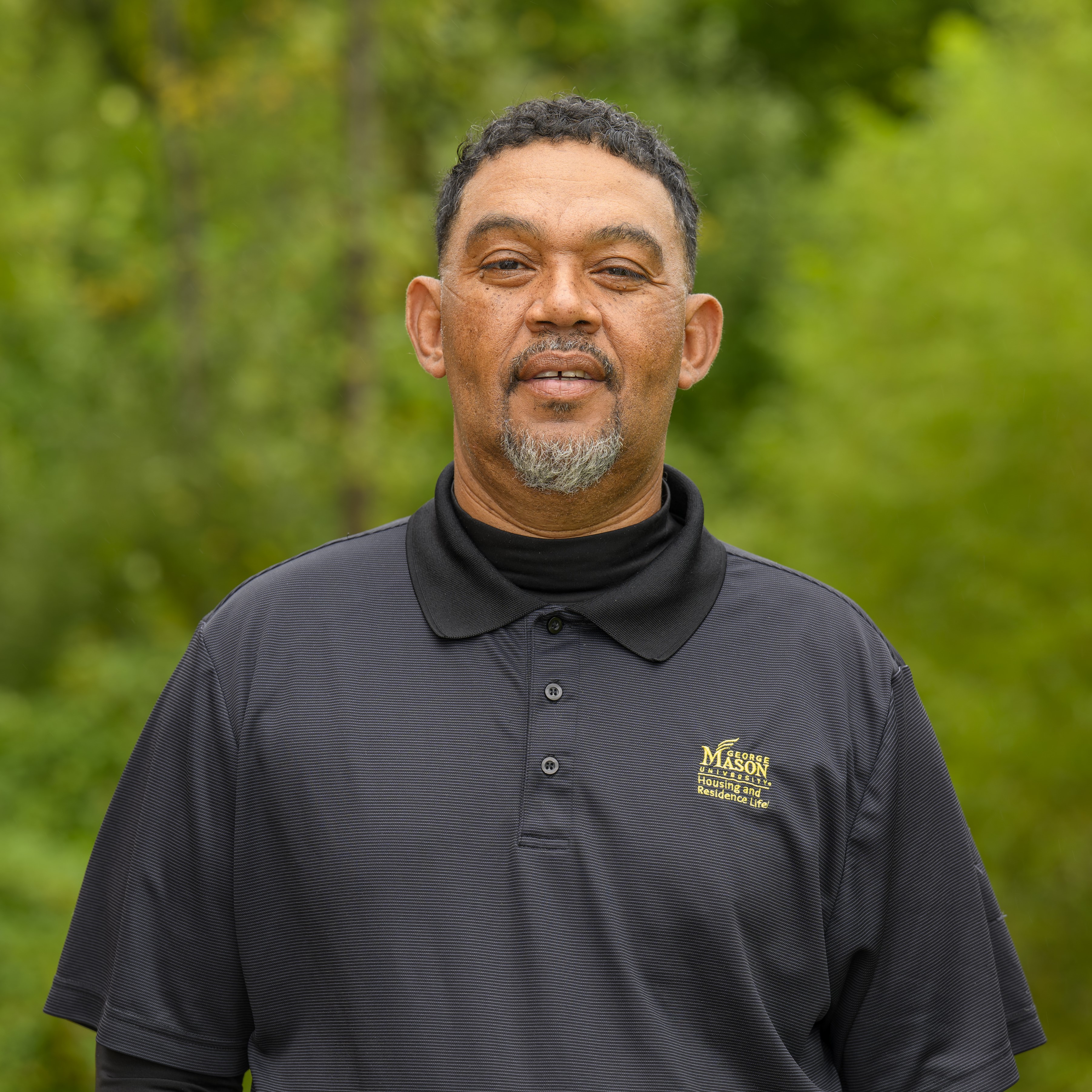 Zach Terrell in a GMU black polo.