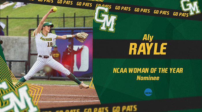 A woman in a white softball uniform with green stripes winds up to throw a yellow softball.