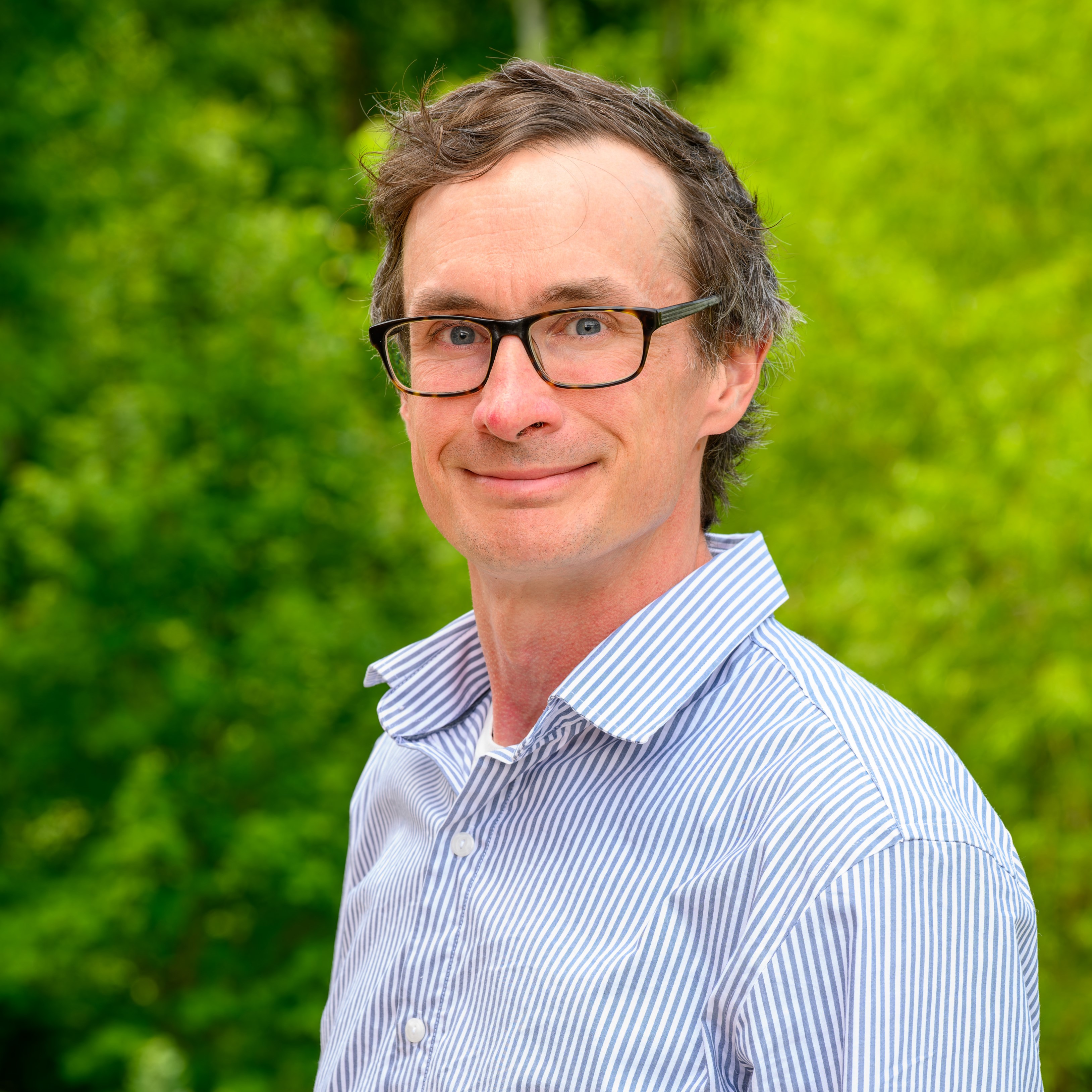 Mike Benedict in a blue polo smiling 