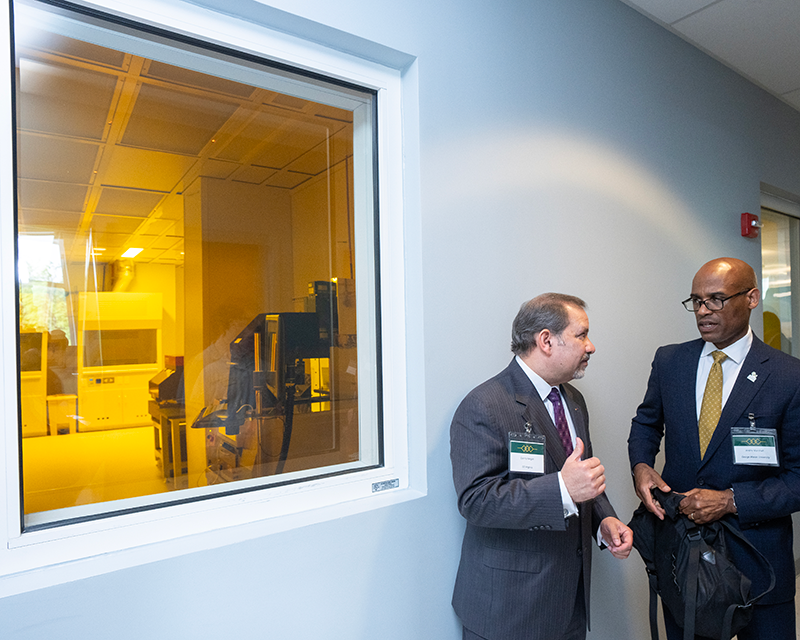 Vice President Andre Marshall (on right) stands outside the clean room.