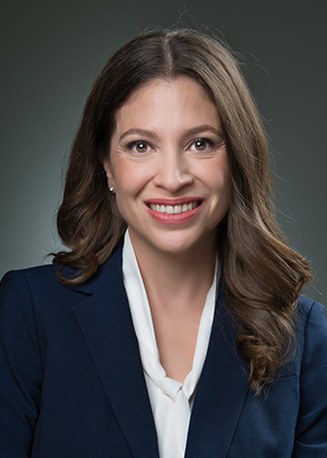 Katherine Cornejo smiling in a suit