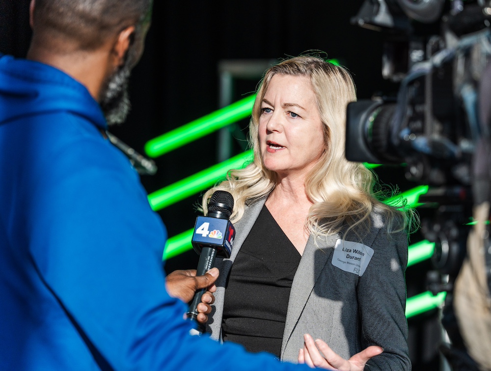 Liza Wilson Durant talks to reporter at opening.