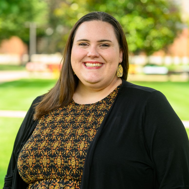 Lex smiling in formal clothing
