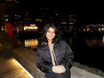 Marisa Parikh standing at a waterfront at night