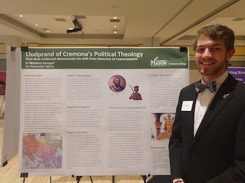 Alex Mertz poses with his research poster