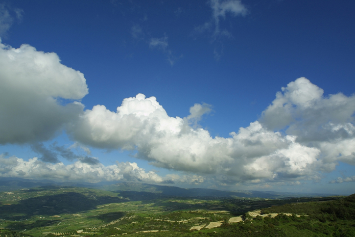 Clouds in a blue sky over mountains