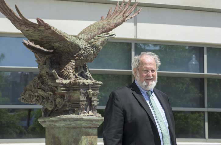 Sculptor Greg Wyatt stands in front of his statue, the Bill of Rights Eagle