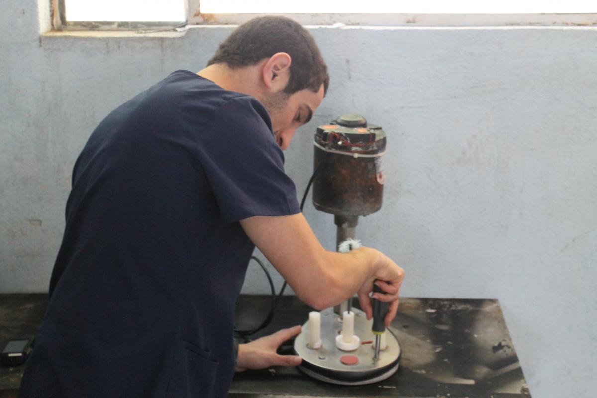 Volgenau School of Engineering student repairing a baby bottle cleaner at a Guatemalan Hospital
