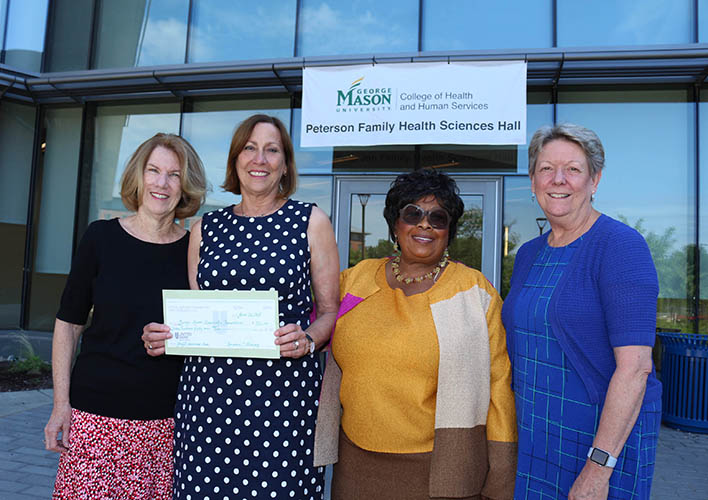 Dr. Kathleen Gaffney, Dean Germaine Louis, Dr. Barbara Hatcher, and Dr. Carol Urban outside Mason's College of Health and Human Services