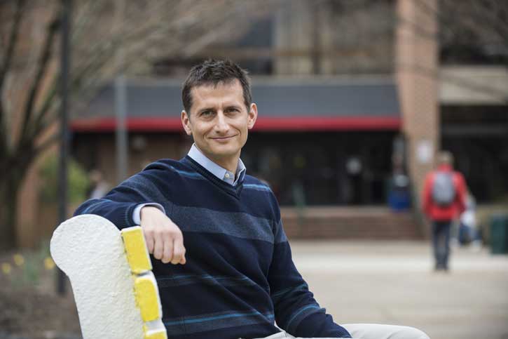 Eric McGlinchey sits on a bench at Mason's Fairfax Campus