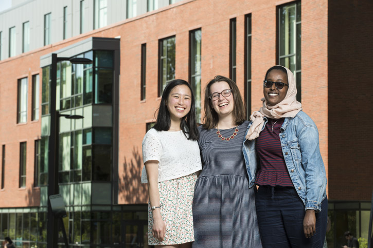 Khue-Tu Nguyen (left), Beverly Harp (center) and Asha Athman (right) stand in front of the Fenwick Library on the Fairfax Campus of George Mason University.