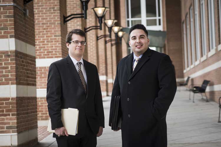 Jameson Goodell and Fernando Cota-Wertz, 3rd year law students stand in front of the Fairfax County Courthouse.