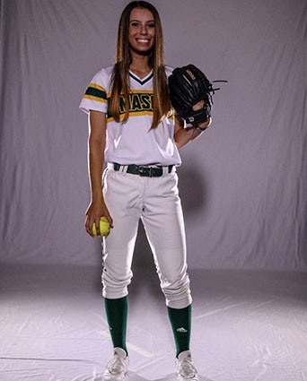 Taylor Dadig standing in front of a white photo background in a Mason softball uniform.