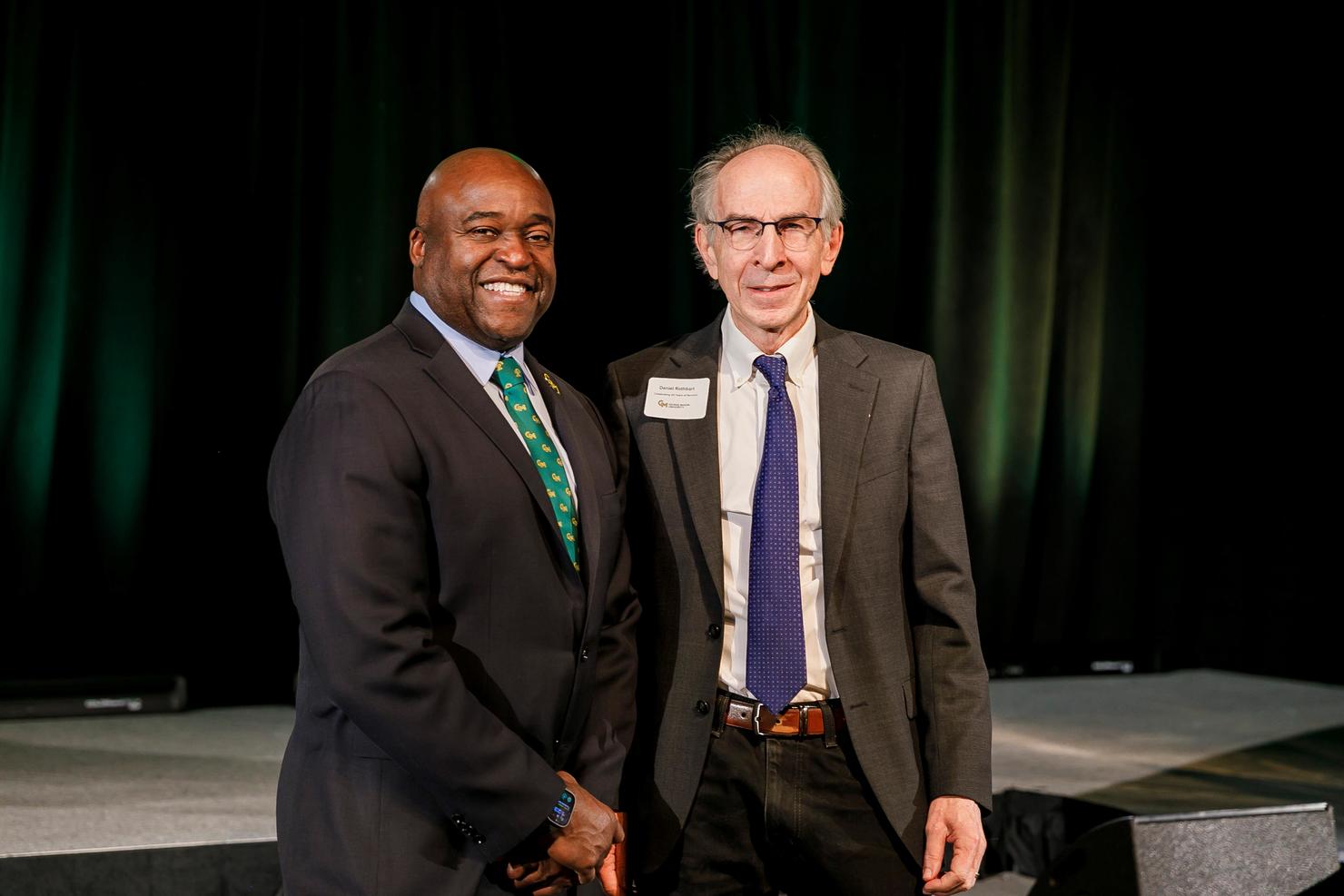 President Gregory Washington and Daniel Rothbart stand together on stage