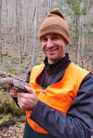 Hunter VanDoren holding a juvenile Wood Turtle during a visual encounter survey. Hunter will be conducting a juvenile survivorship study in Virginia as part of his PhD research at George Mason University. Photo Credit: Jessica Meck