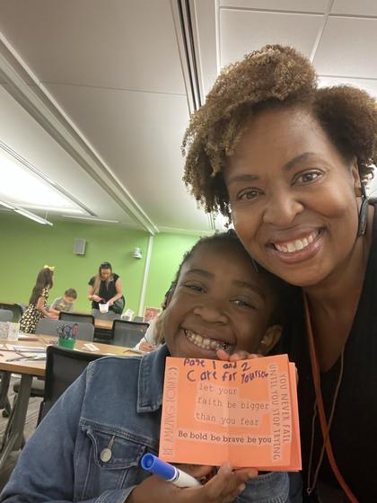 Mason staff member Jacelyn Tyson and her child participate in a craft activity at Take Your Junior Patriot to Work Day