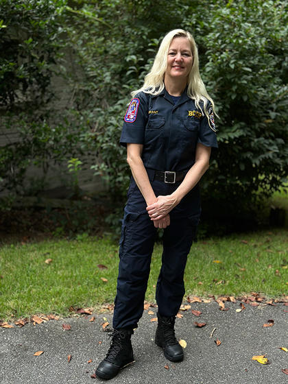 Liza Wilson Durant poses for the camera wearing her EMT uniform.
