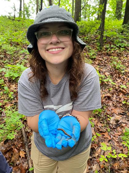 Student holds a salamander