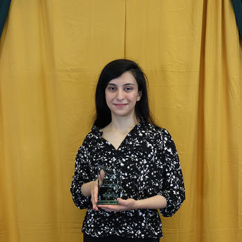 Layan Wahdan, one of the scholarship winners, holds her awards plaque.