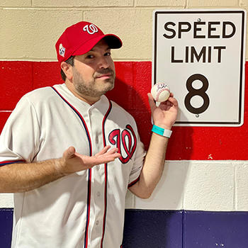 Fifer poses next to a sign indicating his approximate first-pitch speed. Maybe.