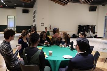 Honors College students gather around a table to practice networking through conversations with top performing arts leaders.