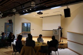 Students and attendees listen to a speaker onstage at the Professional Development Fellows roundtables, an event which give students a unique to connect with industry leaders.