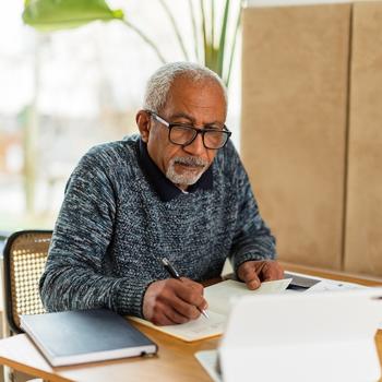 older man writing by hand